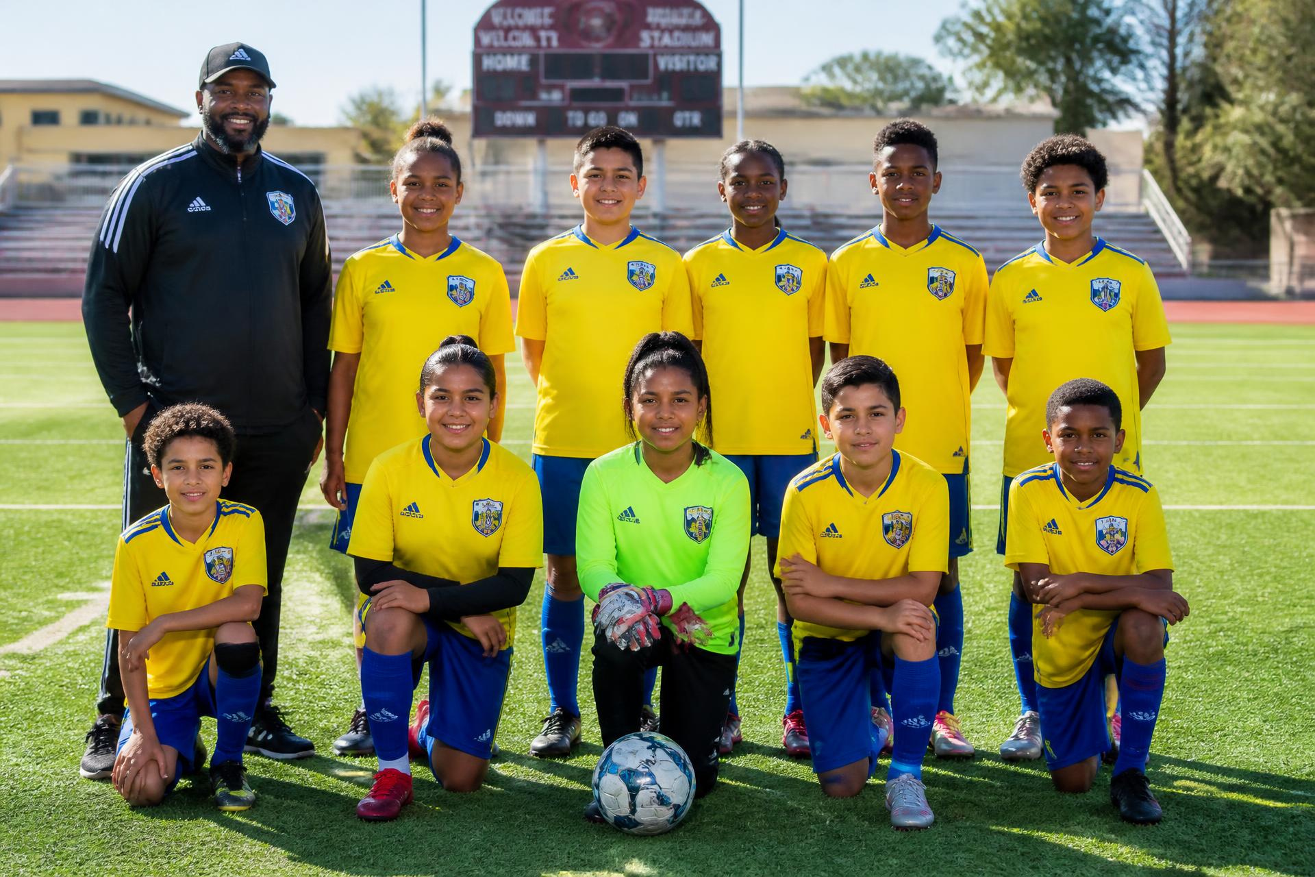 Youth soccer team photo with coach